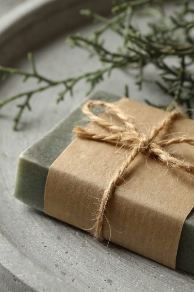 Tray with natural handmade soap on gray background